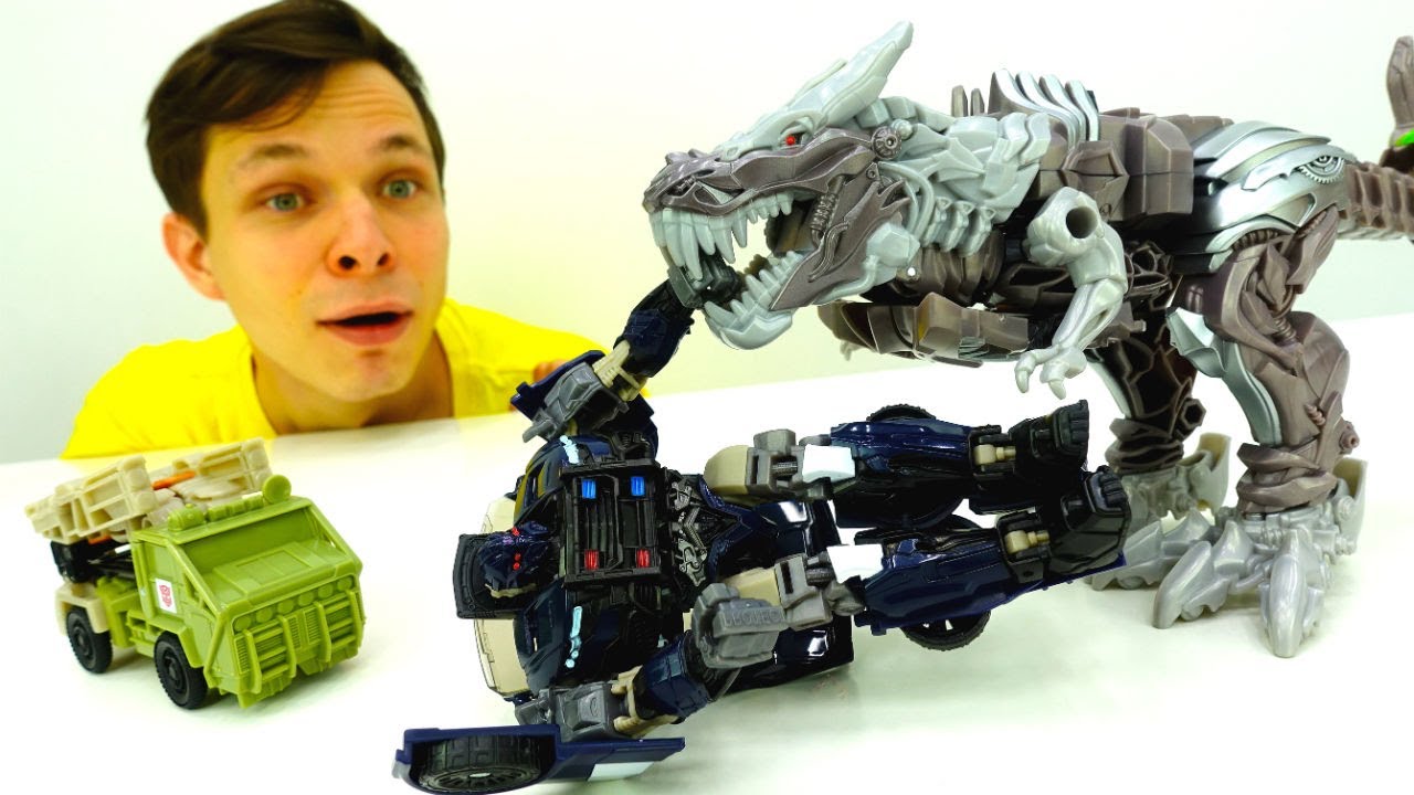 AVTOBOTY-v-opasnosti-Bitva-s-Barrikejdom-no-GDE-OPTIMUS-Roboty-TRANSFORMERY-igrushki-dlya-malchikov