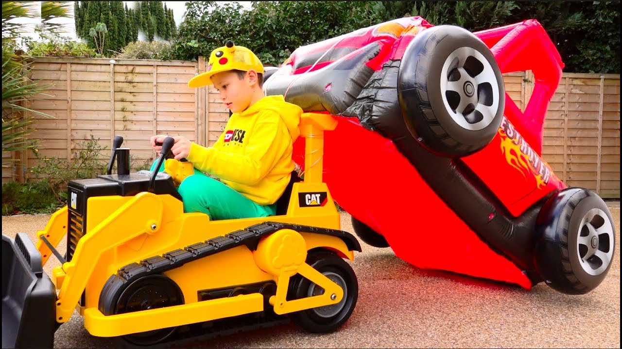 Max-and-Katy-playing-with-Ride-on-Toy-Cars-and-Carriege